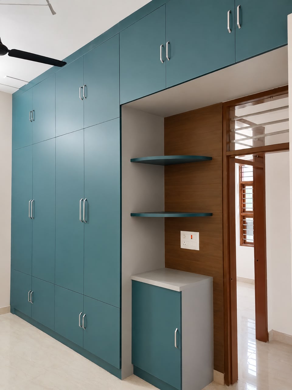 Teal blue floor-to-ceiling wardrobe with curved display